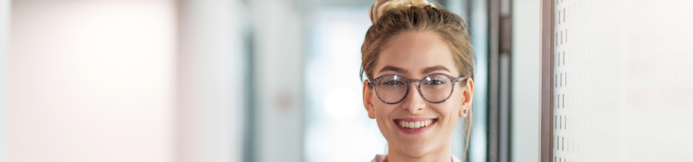 Jonge vrouw met een glimlach kijkt in de camera | Doenpensioen | a.s.r.
